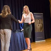 Emily shaking hands with a girl